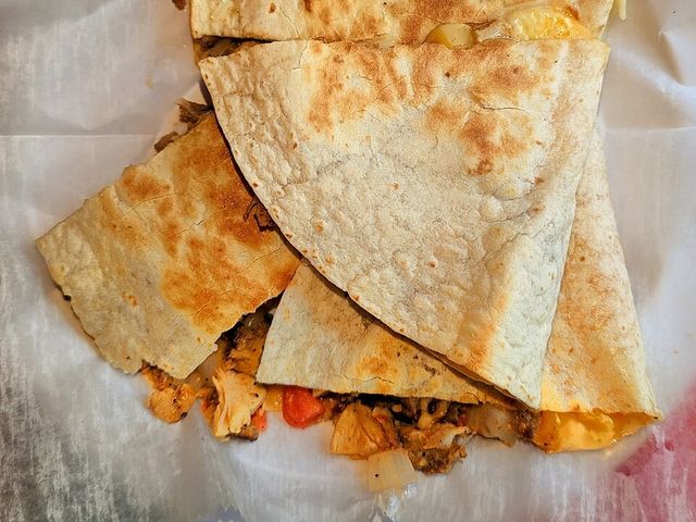 Illustrative photo of a chicken quesadilla cut into wedges